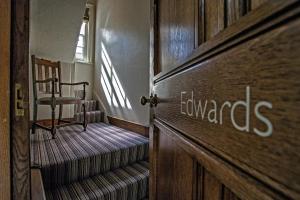 a room with a wooden door and a staircase with a chair at Grays Court Hotel in York