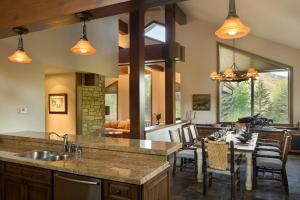 a kitchen with a table and a dining room at Skyline Drive - 108 in Elkhorn Village