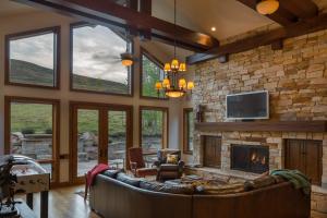 a living room with a stone fireplace and a couch at Skyline Drive - 108 in Elkhorn Village