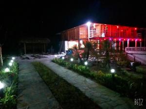 a building lit up at night with lights at Homestay Làng Châng in Ha Giang