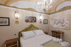 Postel nebo postele na pokoji v ubytování Les Suite Royales