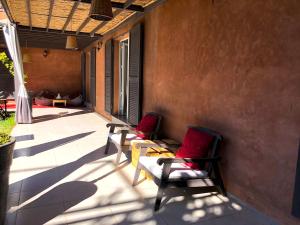 zwei Stühle auf der Veranda eines Hauses in der Unterkunft Palais Akki in Marrakesch