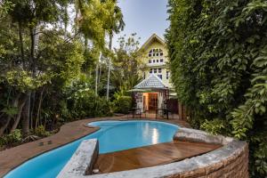 a swimming pool in front of a building at The Twenty Lodge- SHA Extra Plus in Chiang Mai