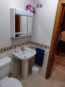 a bathroom with a sink and a toilet and a mirror at Minute walk to the beach in Munxar +9 photos