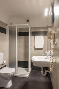 a bathroom with a shower and a toilet and a sink at Hotel Principe in Sanremo