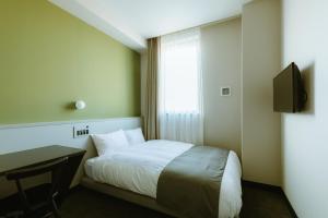 Säng eller sängar i ett rum på HOTEL KARAE