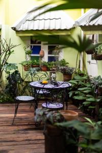 a table and two chairs on a deck with plants at The Twenty Lodge- SHA Extra Plus in Chiang Mai