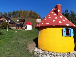 a toy house with a red and yellow roof at Chata Katka in Dolný Kubín