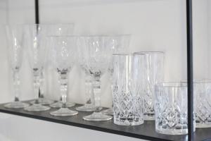 a row of clear glasses sitting on a shelf at Ferienwohnung Stöckel in Cuxhaven