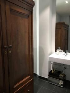 baño con lavabo y puerta de madera en A casa di..., en Milán