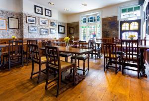 a dining room with wooden tables and chairs at Black Lion in Surbiton