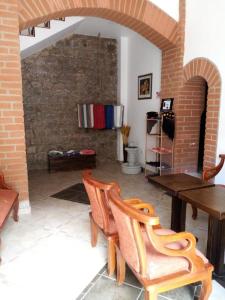 a room with a table and chairs and a brick wall at Hotel Casa Ecuatreasures Centro Historico in Quito +22 photos