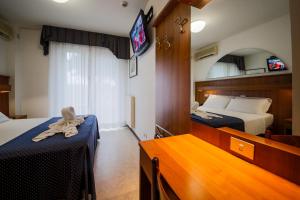 A bed or beds in a room at Hotel Vina De Mar