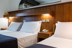 A bed or beds in a room at Hotel Vina De Mar