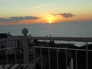 a sunset from the balcony of a condo at Ericeira Sunset Apartment in Ericeira
