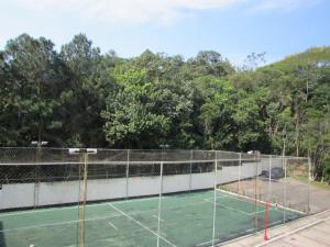 a tennis court with a tennis on top of it at Apê da Gabi in Balneário Camboriú