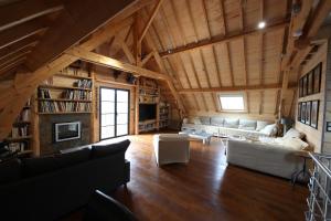 a large living room with a couch and a fireplace at Chalet Montagne in Saint-Pastous