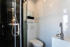 a bathroom with a shower and a toilet and a sink at Hôtel Le Mistral in Marseille