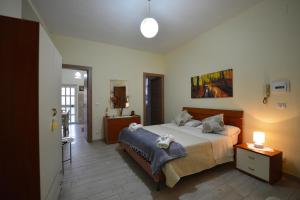 a bedroom with a large bed and a mirror at IL PARADISO DEGLI DEI 2 in Agerola