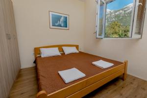 a bedroom with a bed with two white towels on it at Villa Relax in Herceg-Novi
