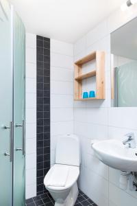 a bathroom with a toilet and a sink at Brink Hotell in Eslöv