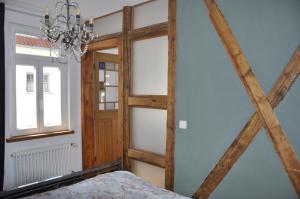 a bedroom with a wooden door and a window at Geibelhof in Karben