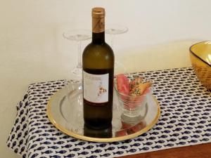 a bottle of wine on a plate with a bowl of watermelon at Laetitia in Porto Santo Stefano +16 photos