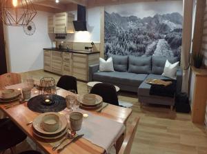 a living room with a table and a couch at Domek Góralski u Basisty in Poronin +12 photos