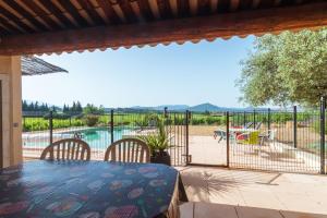 a patio with a table and chairs and a pool at La Provence in Vaison-la-Romaine