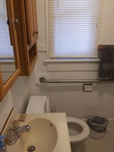 a bathroom with a toilet and a sink and a window at Bright and Cool Powell Apartment in Powell +46 photos