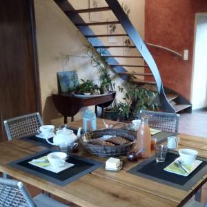 a wooden table with a basket of food on it at Clos de l'Arthonnet in Flavignac