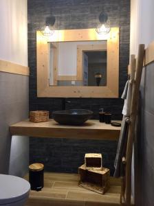 a bathroom with a sink and a mirror at Domek Góralski u Basisty in Poronin