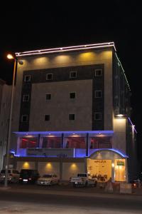 a building with cars parked in front of it at night at دار آل زاهب للشقق المفروشه in Tabuk