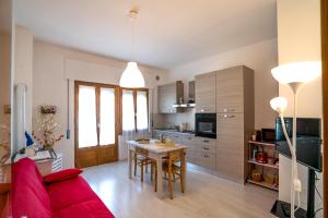 ein Wohnzimmer mit einem roten Sofa und einem Tisch in der Unterkunft Cozy Home in Monte Amiata in Abbadia San Salvatore