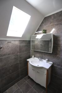 a bathroom with a sink and a mirror at P-ZLATAR, apartman 3 in Brdo