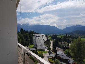 a balcony with a view of a town and mountains at Mountain View Apartment in Bad Mitterndorf