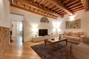 a living room with a couch and a table at Mamo Florence - San Lorenzo Apartment in Florence