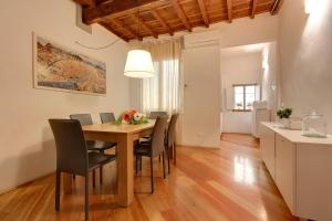 a dining room with a table and chairs at Mamo Florence - San Lorenzo Apartment in Florence
