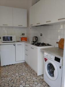 a white kitchen with a washing machine in it at Casa Tina in Santa Margherita Ligure