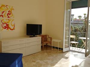 a living room with a tv on a dresser at Casa Tina in Santa Margherita Ligure