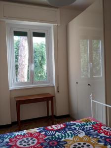 a bedroom with a bed and two windows at Casa Tina in Santa Margherita Ligure