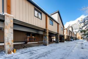 a row of buildings on a snow covered street at Mount Royal Townhome in Frisco