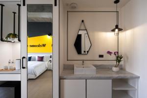 a bathroom with a sink and a room with a bed at Tian Zhong Hotel in Tianzhong