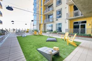 an apartment patio with a lawn with chairs and tables at Sonder at McKinley in Phoenix