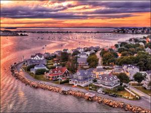 an aerial view of a town on the water at sunset at The Beacon Waterfront Inn in Hull