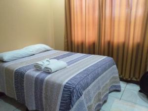 um quarto com uma cama com duas toalhas em Casa la Fortuna 1 em La Fortuna