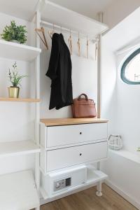 a closet with white dressers and a purse at Bairro Alto Bronze of Art Apartments in Lisbon