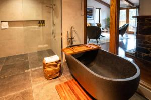 a large bathroom with a tub and a shower at Peppers Cradle Mountain Lodge in Cradle Mountain
