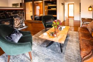 a living room with a couch and a table at Peppers Cradle Mountain Lodge in Cradle Mountain