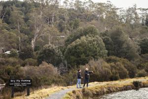 two people standing on a path near a river at Peppers Cradle Mountain Lodge in Cradle Mountain